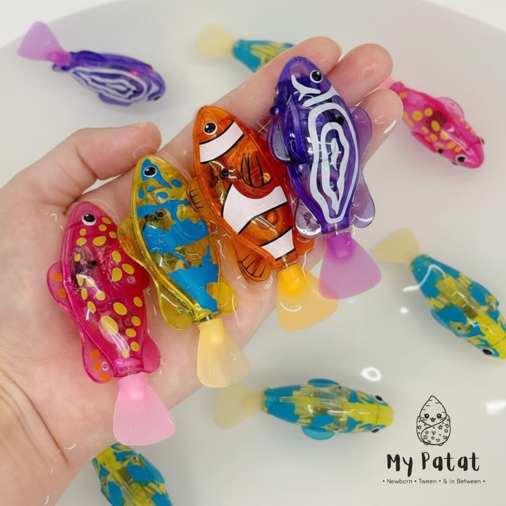 Hand holding wind-up swimming fish toys in water