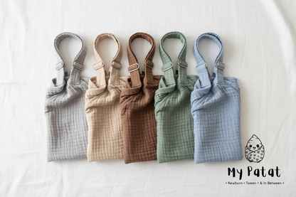 All 5 colour variants of muslin nursing cover flat lay - grey, beige, mocha, sage green, blue