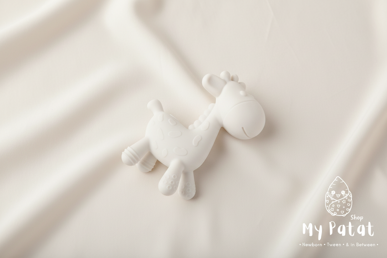 White silicone giraffe teething toy flat lay on light background with My Patat Shop logo