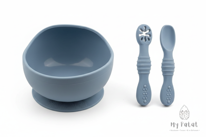 Dusty blue silicone baby suction bowl and spoons on white background