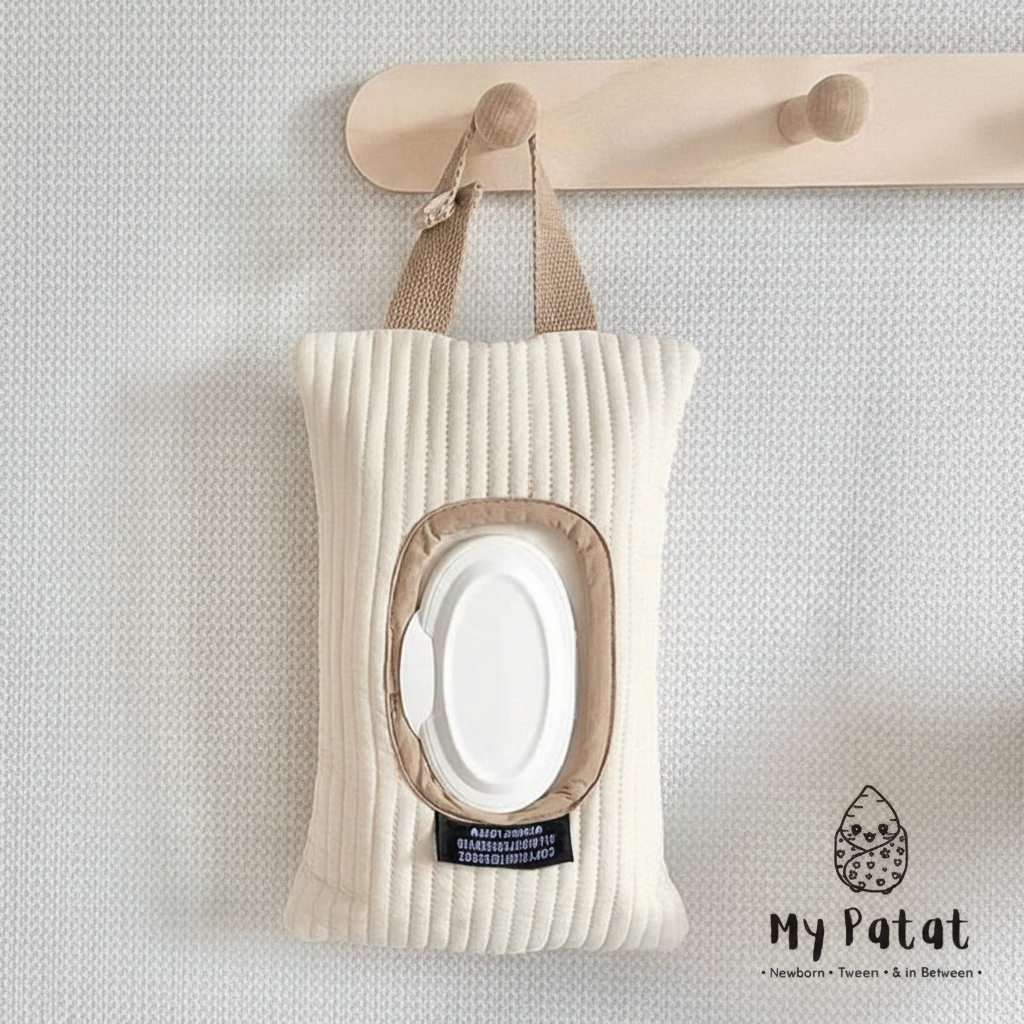 Ribbed cream baby wipes pouch hanging on peg rail
