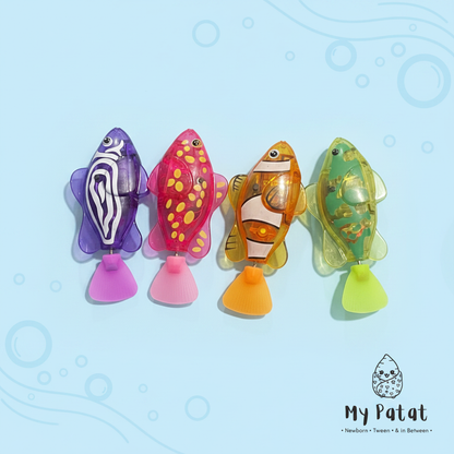 Four colourful wind-up swimming fish bath toys on pastel blue background
