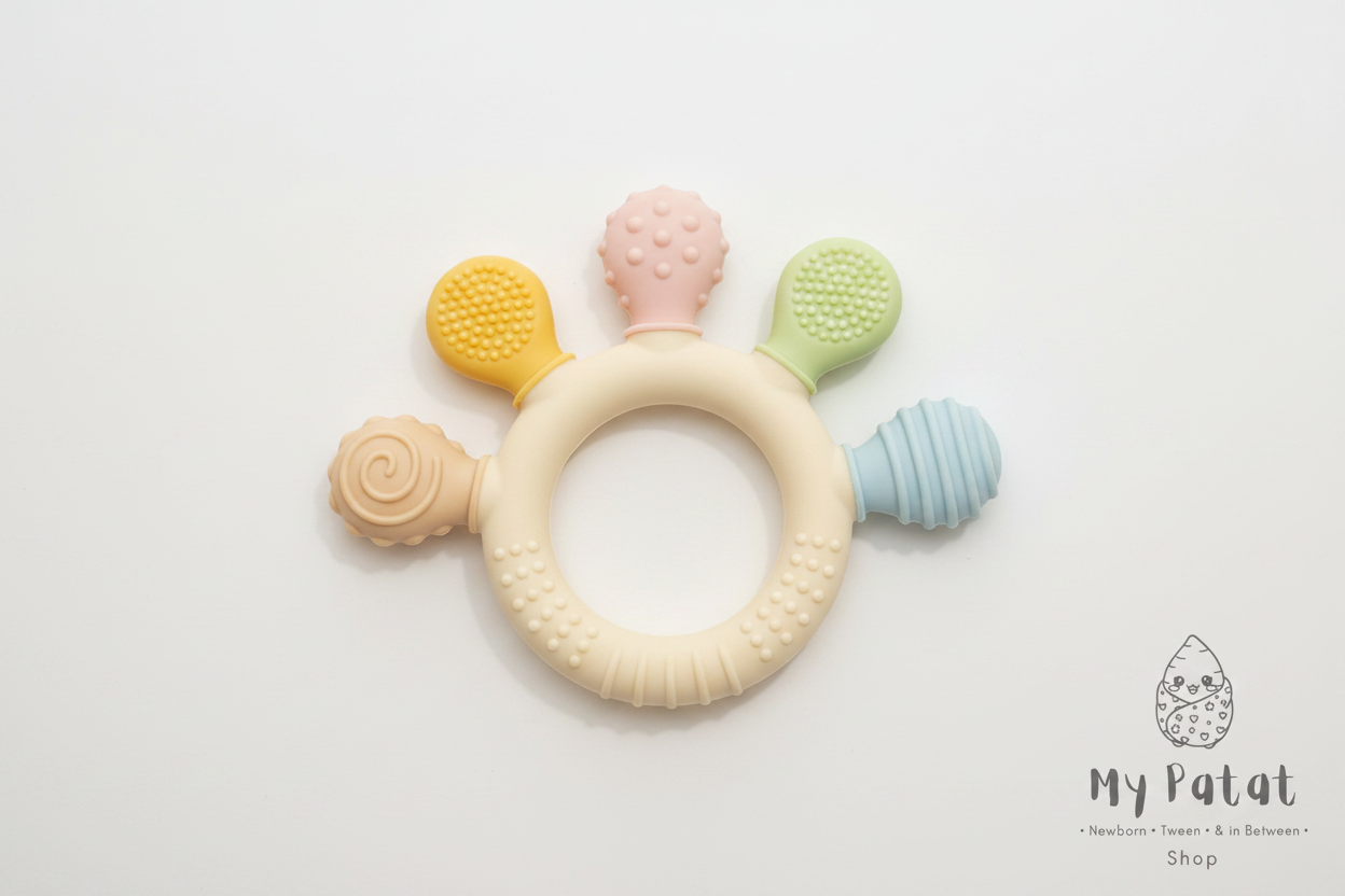 Colourful silicone baby teething ring on soft white background with My Patat Shop logo